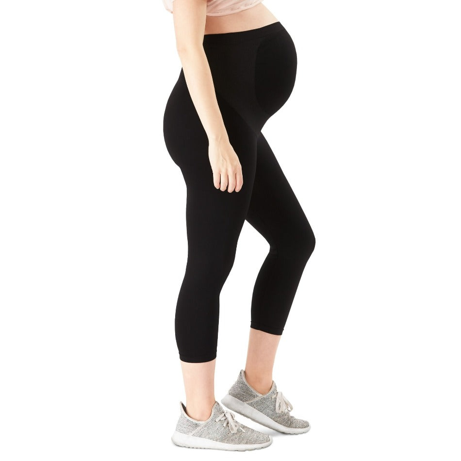 Black, capri-length leggings designed to support a growing baby bump during pregnancy.